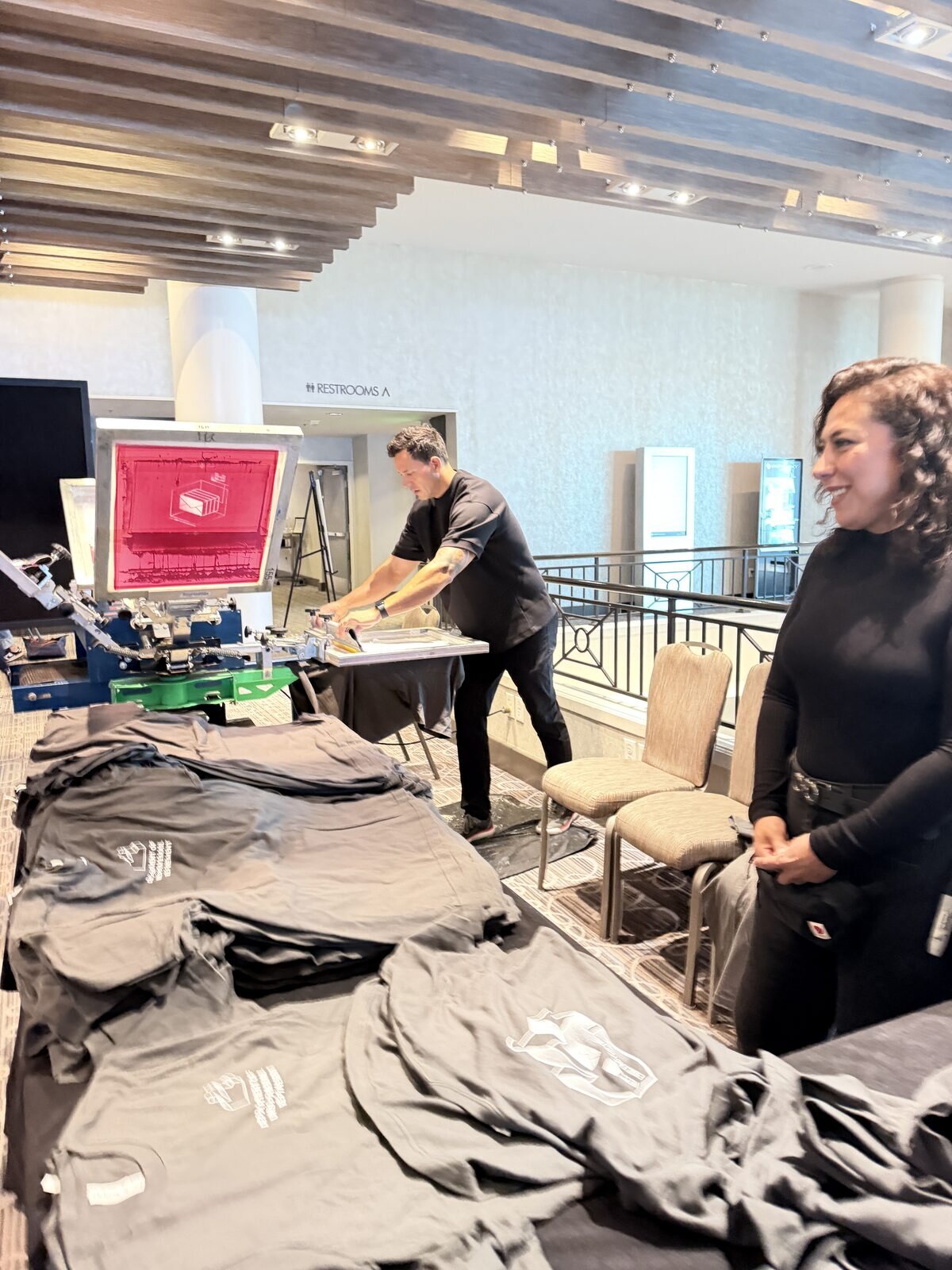 Merch Troop live printing — fresh prints off the platen